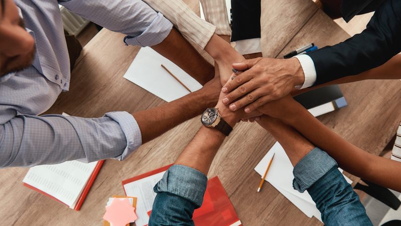 strong-team-top-view-of-business-people-holding-h-2025-03-26-19-35-04-utc-1